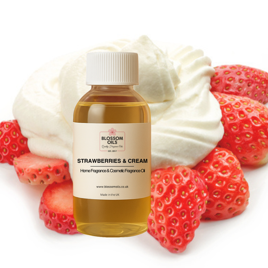 Bottle of 'Strawberries & Cream' fragrance oil by Blossom Oils with strawberries and cream on a white background